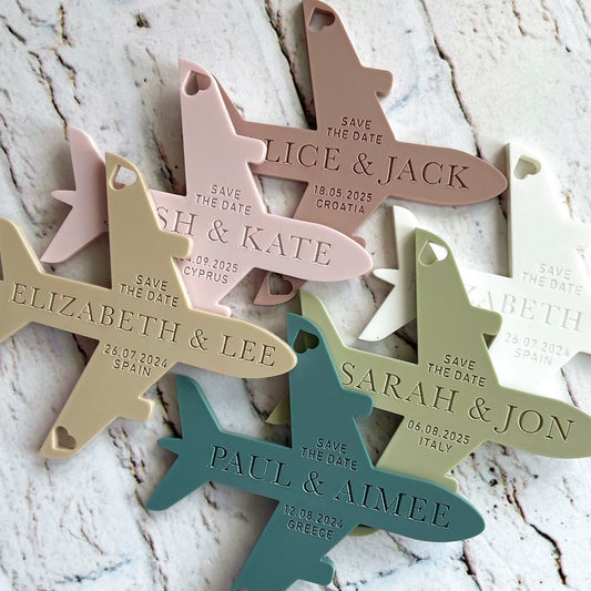 plane shaped fridge magnet save the dates engraved with couples names and wedding date
