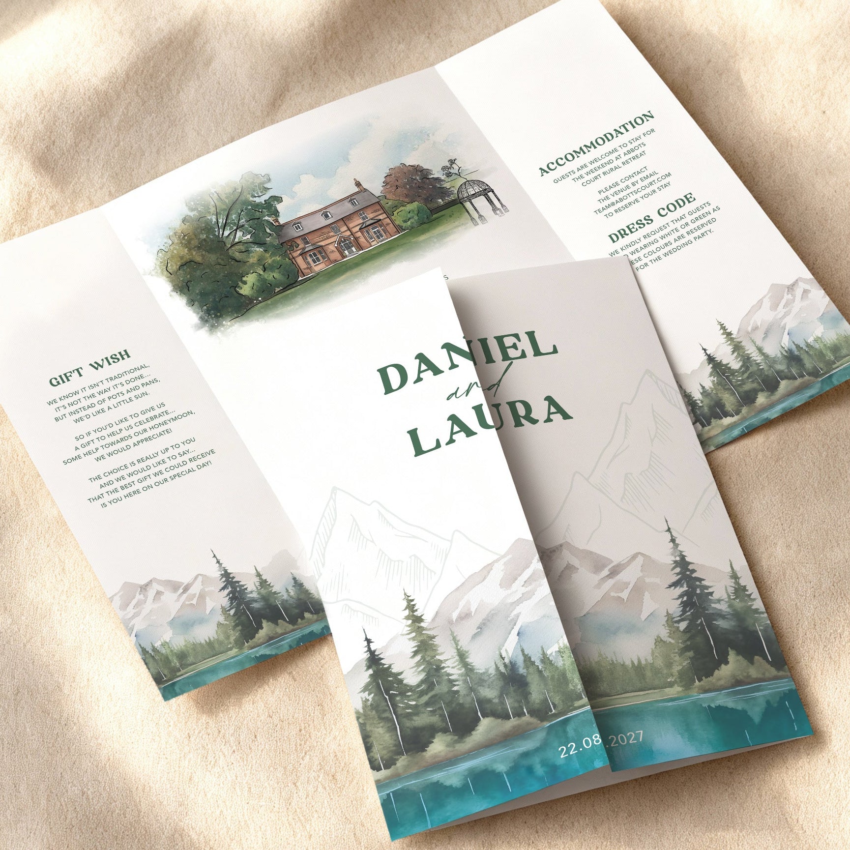 lakes and mountain theme wedding invitations, folded wedding invitations with blue lake, mountains and forest. With watercolour venue painting, itinerary and gift poem. Mountain design inspired by Canada