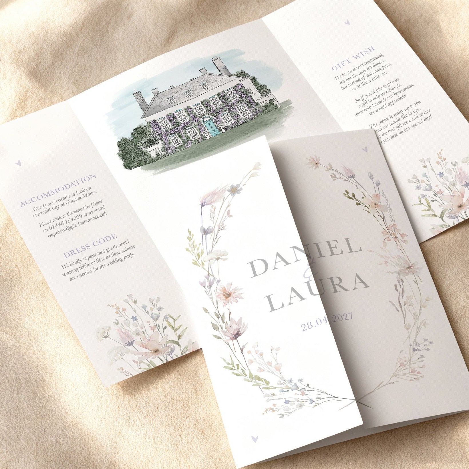 bespoke folded Wedding invitation card with floral wildflower design for a spring summer wedding with a watercolour venue illustration painting 